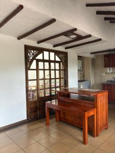 a kitchen with a wooden table in a room at Pueblito Boyacense Hospedaje Iraca Duitama in Duitama