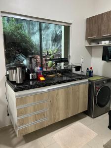 a kitchen with a sink and a stove top oven at Casa com suite bem localizada in Manaus +26 photos