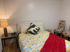 a bedroom with a bed with a cow pillow on it at Four Seasons Garden in Whitehorse +2 photos