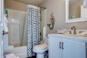 a bathroom with a toilet and a sink and a shower at Ocean Front 2BR, 2BA Home! - A Shore Thing! in Waldport +28 photos