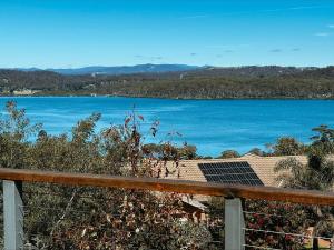 a view of a large body of water from a balcony at Snapper Hideaway - Pet Friendly in Merimbula +2 photos