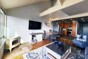 a living room with a couch and a table at Historic Bayfront! Stellar Bridge & Bay Views! Bay Dreaming in Newport