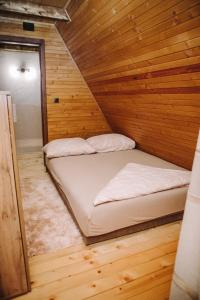 a room with two beds in a wooden cabin at Vikendica Buzadzija M&N in Piskavica +35 photos