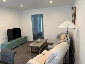 un soggiorno con due divani e una TV di Charming Home a Lower Hutt