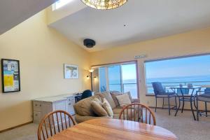 a living room with a couch and a table with chairs at Nye Beach Ocean Front Condo! Ocean Memories in Newport