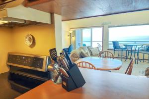 a kitchen and living room with a couch and a table at Nye Beach Ocean Front Condo! Ocean Memories in Newport