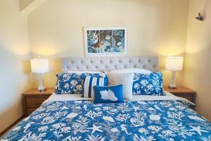 a bedroom with a blue and white bed with two lamps at Nye Beach Ocean Front Condo! Ocean Memories in Newport