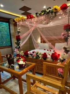 a bedroom with a bed with flowers on it at Arcadian Resort Skardu in Skardu
