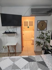 a room with a bed and a toilet and a door at Cozy & comfortable crib in Carolina