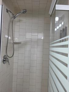 a shower in a bathroom with white tiles at Togather Time,5 minutes to HYW 401 in Oshawa +14 photos