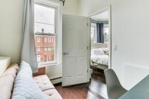 a living room with a couch and a bed and a mirror at Explore and Work! Stylish Washington Heights Duplex in Newburgh