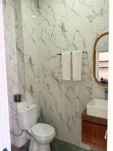 a bathroom with a toilet and a sink at Mesari Living Bali in Denpasar
