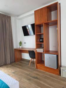 a bedroom with a desk and a book shelf at CASA GALAPAGOS by Hostal Fragata in Puerto Ayora