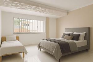 a bedroom with a large bed and a window at COP30 - Casa com 3 quartos para alugar in Belém