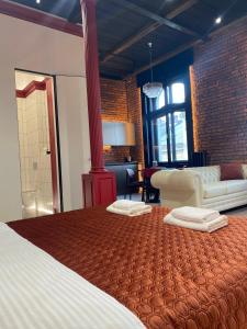 a bedroom with a large bed with two pillows on it at Old city apart in Ivano-Frankivsʼk