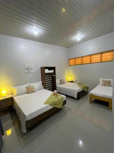 a room with two beds and two tables sidx sidx sidx sidx at BC Lodge in Puerto Princesa City
