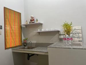 a kitchen counter with a sink and a shelf at BC Lodge in Puerto Princesa City +33 photos