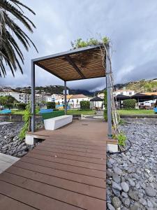 a wooden walkway with a pavilion in a park at Dª Xica Holidays in Santa Cruz