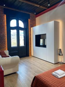 a living room with a couch and a tv in a room at Old city apart in Ivano-Frankivsʼk