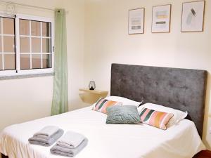 a bedroom with a white bed with towels on it at Dª Xica Holidays in Santa Cruz +36 photos