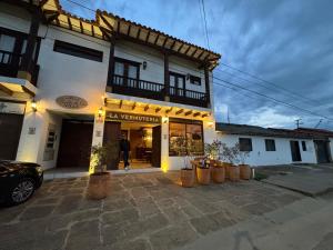 a store front of a building with lights on it at PUERTA DE LA VILLA Apartamentos y Habitaciones in Villa de Leyva