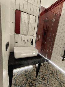 a bathroom with a sink and a mirror at Old city apart in Ivano-Frankivsʼk +21 photos