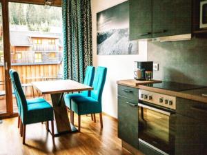 a kitchen with a table and chairs and a table and a stove at Bösenstein in Hohentauern
