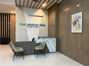 a lobby with a counter and chairs in a building at Aspen Suites Condo in Davao City +2 photos