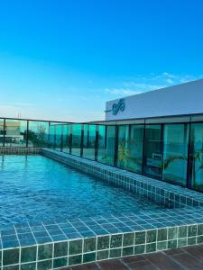a swimming pool in front of a building at Mahrak Villa - VSH in Porto De Galinhas