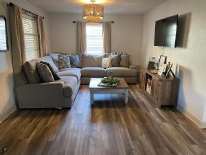 a living room with a couch and a table at Cozy two-bedroom cottage close to everything! in Oak Island