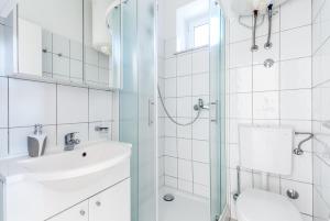 a white bathroom with a sink and a shower at Apartments by the sea Duce, Omis - 946 in Duće +76 photos