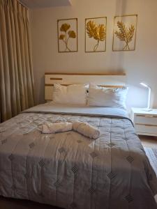 a bed with a towel laying on top of it at Mysuites2go24K Parksuites T2 in Manila +32 photos