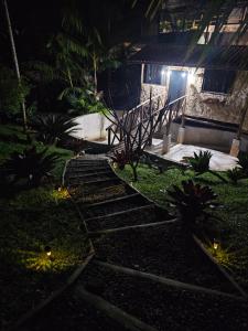 a set of stairs leading to a house at night at Chalé dos Açaís próximo à Trindade in Paraty