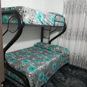 a bunk bed in a room with a curtain at Hogar tranquilo con piscina in Ibagué
