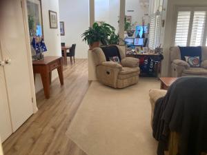 a living room with two chairs and a table at HOME STAY on HIGH Queen Bed -Private Home -Private Bathroom in Swan Hill