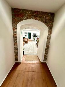 a hallway with a stone wall in a house at Hotel Bugambilia in Zimapán