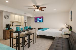 a bedroom with a bed and a kitchen with a table at Hot Tub WiFi Gym Firepit Kitchen in Kernersville +11 photos