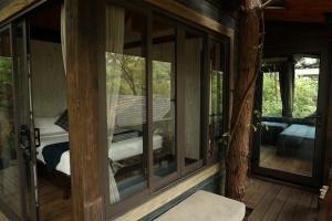 a screened in porch with a view of a bedroom at Amaya Retreat in Sóc Sơn