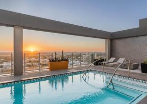 a swimming pool on top of a building with a view at Boulevard Stays Comfortable Downtown Highrise STU Pool Parking & Gym 10a in Phoenix