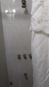 a man standing in a shower in a bathroom at Okin 9 cristina in Costa del Este