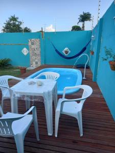 a table and two chairs on a wooden deck at Hostel Ariramba in Belém