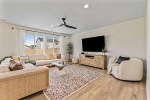 a living room with two couches and a flat screen tv at 6BR Retreat with Playground Basketball & Sleeps 22 in Star