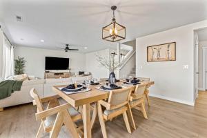 a dining room and living room with a table and chairs at 6BR Retreat with Playground Basketball & Sleeps 22 in Star