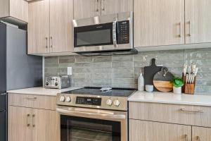 a kitchen with a stove and a microwave at 6BR Retreat with Playground Basketball & Sleeps 22 in Star +41 photos