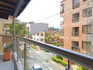 a balcony with a view of a street and buildings at Casa de Huéspedes Colibrí in Envigado