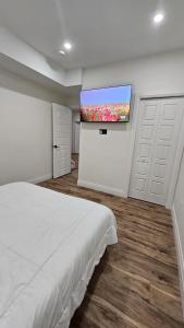 a bedroom with a bed and a flat screen tv at Windsor Perfect Stay in Windsor