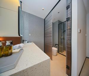 a bathroom with a sink and a toilet at Leaf Hotel in Yantaiqian