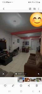 a living room with a couch and a smiley face on the ceiling at Suite confortável prox a COP 30 in Belém