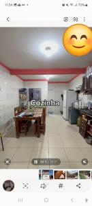 a kitchen with a table and a smiley face on the ceiling at Suite confortável prox a COP 30 in Belém