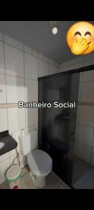 a bathroom with a toilet and a smiley face on the wall at Suite confortável prox a COP 30 in Belém +4 photos